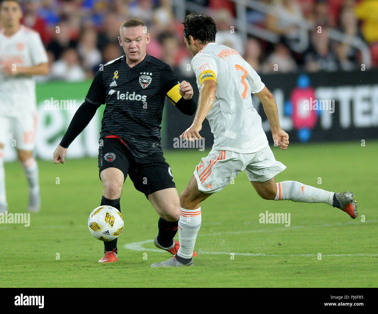 September 2, 2018 - Washington, DC, USA - 20180902 - D.C. United forward WAYNE ROONEY (9) launches a pass against Atlanta United FC defender MICHAEL PARKHURST (3) in the first half at Audi Field in Washington. (Credit Image: © Chuck Myers/ZUMA Wire) Stock Photo
