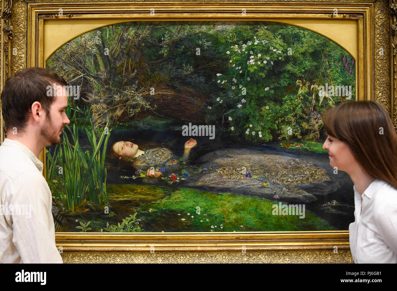London, UK.  5 September 2018.  Staff members view 'Ophelia', 1851-52, by John Everett Millais, at Tate Britain, to mark the launch of a major new exhibition at the National Gallery of Australia (NGA) in December 2018.  Over forty Pre-Raphaelite works will be loaned by Tate to NGA, which have never been shown in Australia until now, including 'Ophelia', 1851-52, by John Everett Millais and 'The Lady of Shalott', 1888, by John William Waterhouse. Credit: Stephen Chung / Alamy Live News Stock Photo