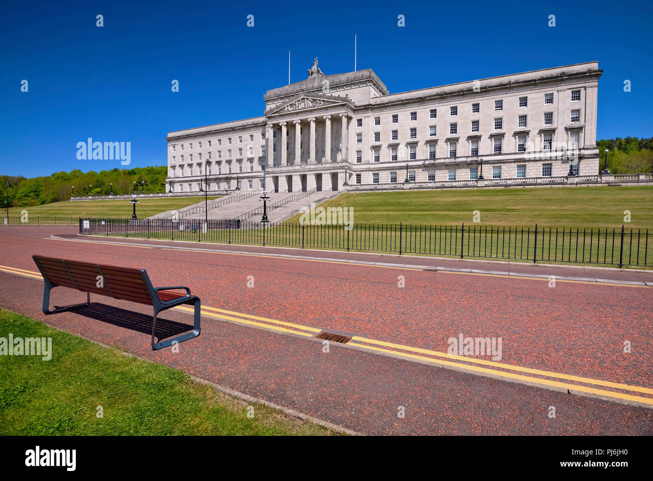Northern Ireland, Belfast, Stormont, Parliament or Northern Ireland Assembly Buildings with double yellow lines and seat on roadway in the foreground. Stock Photo