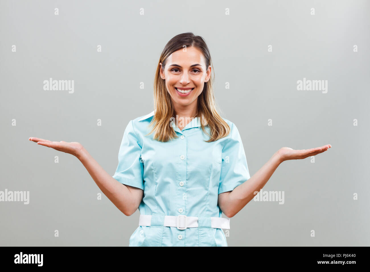 Smiling female nurse gesturing hi-res stock photography and images - Alamy