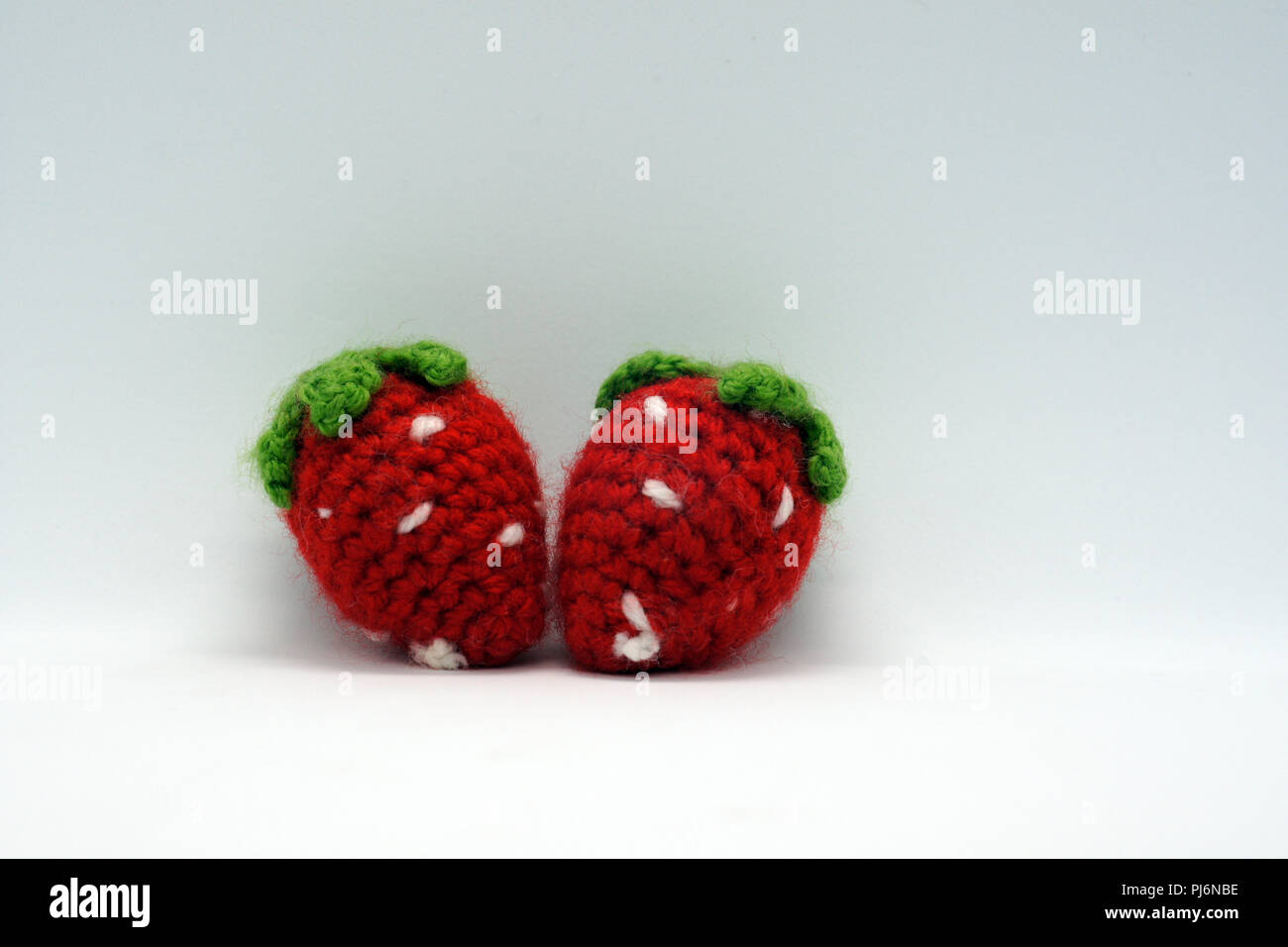 two red crocheted strawberrys Stock Photo