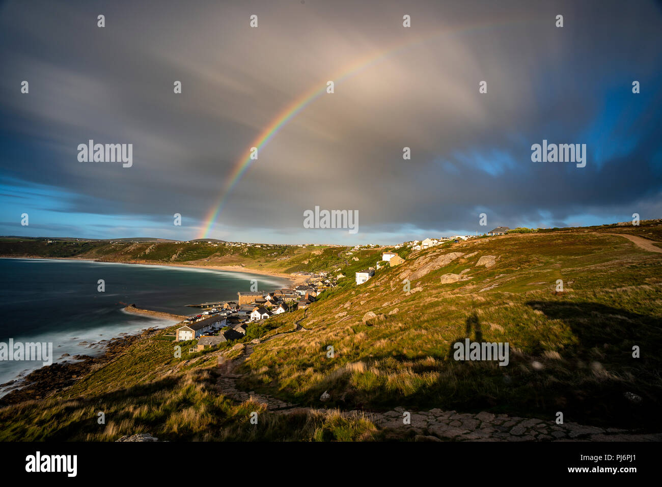 Huge double rainbow engulfs the beautiful Sennen Cove in Cornwall Stock Photo