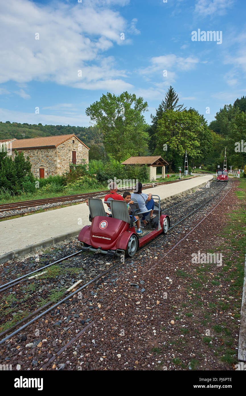 Tourists riding on the velorail between Lamastre and Boucieu-le-Roi in the Ardeche region, France. Stock Photo