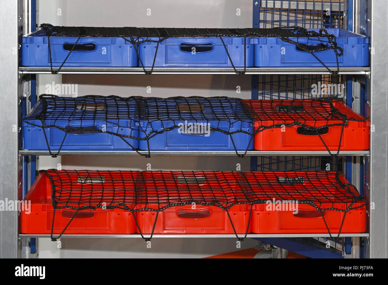 Plastic crates with safety net in shelf Stock Photo Alamy