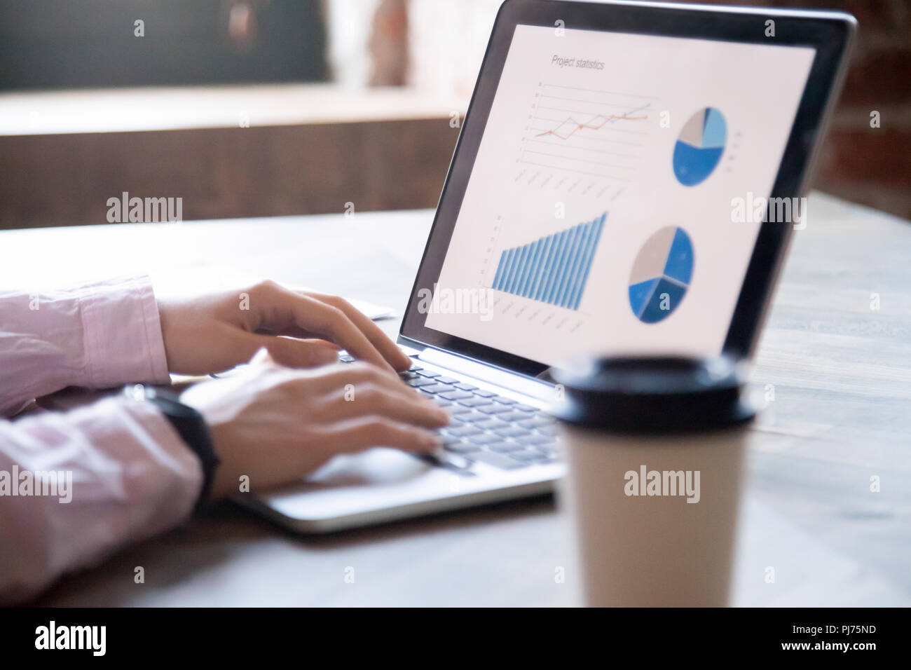 Close up of womans hands working on laptop Stock Photo
