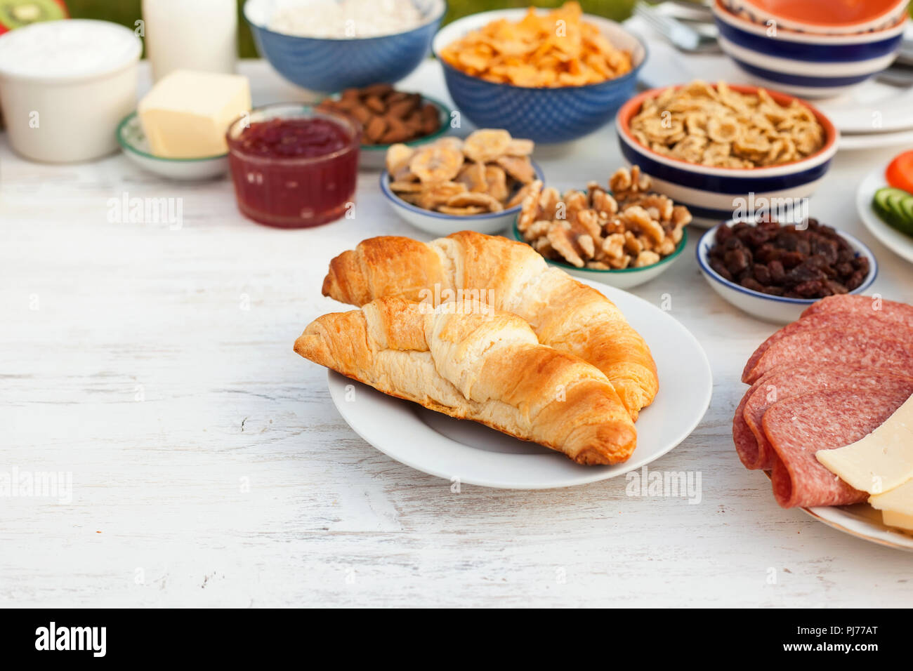 Healthy continental breakfast served in the garden, ham, cheese