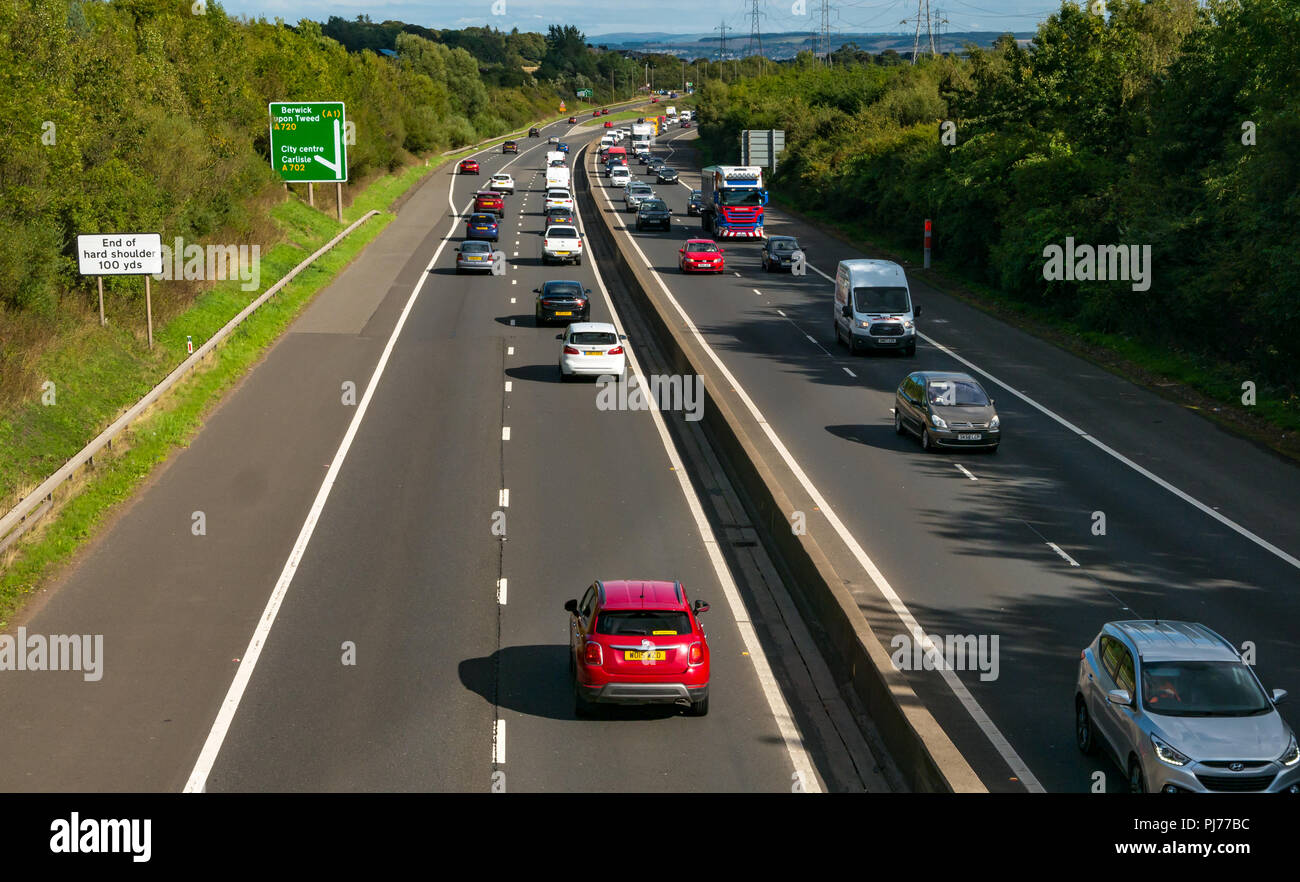 Cars and lorry in traffic on Edinburgh City dual carriageway bypass viewed from bridge overpass with road sign to Berwick Upon Tweed, Scotland, UK Stock Photo