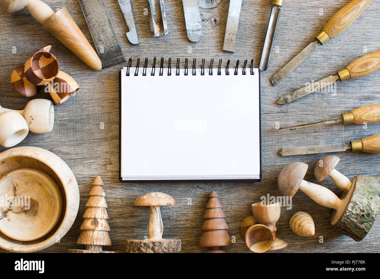 Old used chisels and wooden toys turned on the wood lathe, copy space