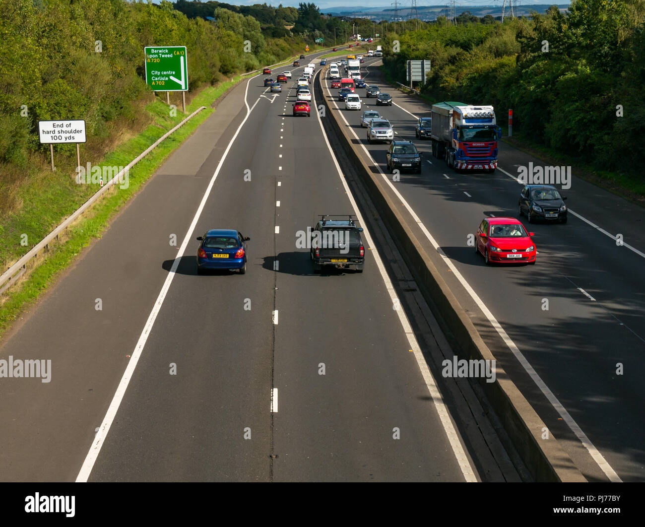 Cars and lorry in traffic on Edinburgh City dual carriageway bypass viewed from bridge overpass with road sign to Berwick Upon Tweed, Scotland, UK Stock Photo