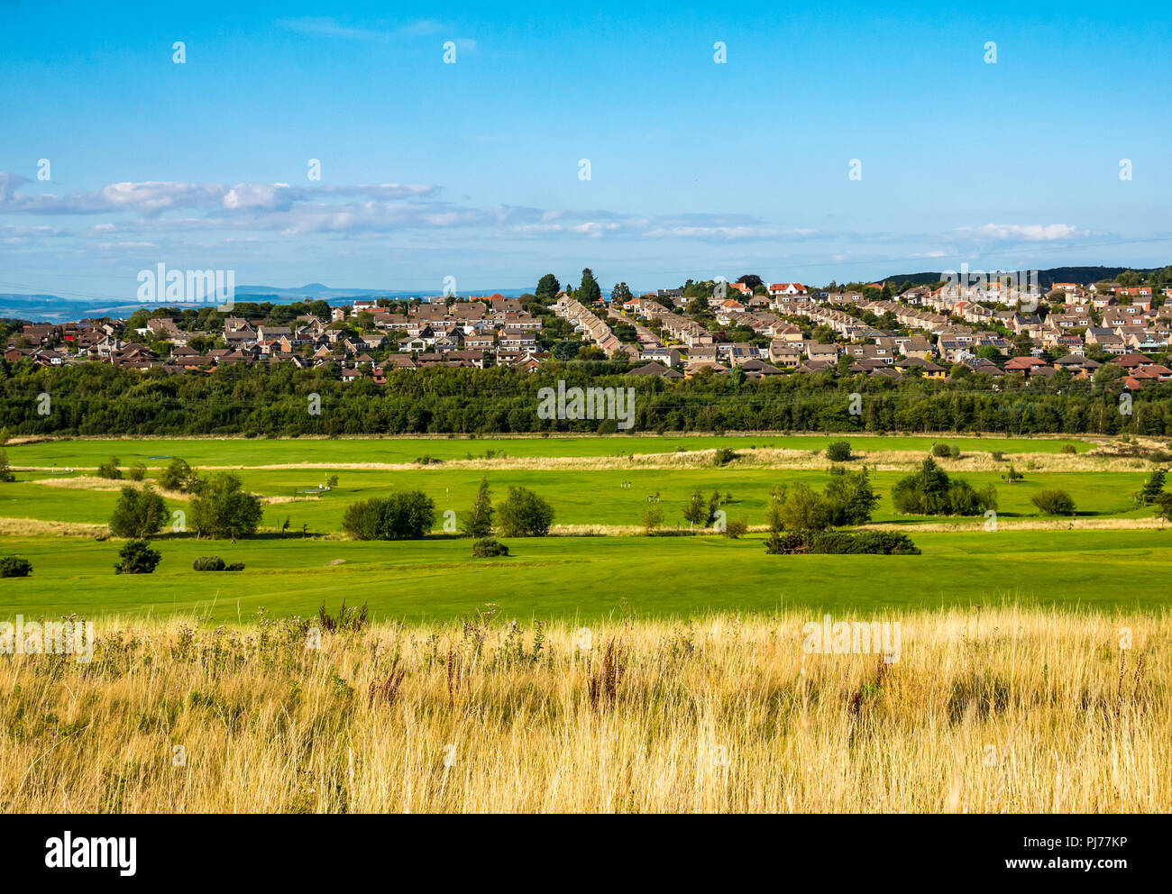View across Swanston golf course to South Edinburgh houses and Fife in the distance on Summer day with blue sky, Edinburgh, Scotland, UK Stock Photo