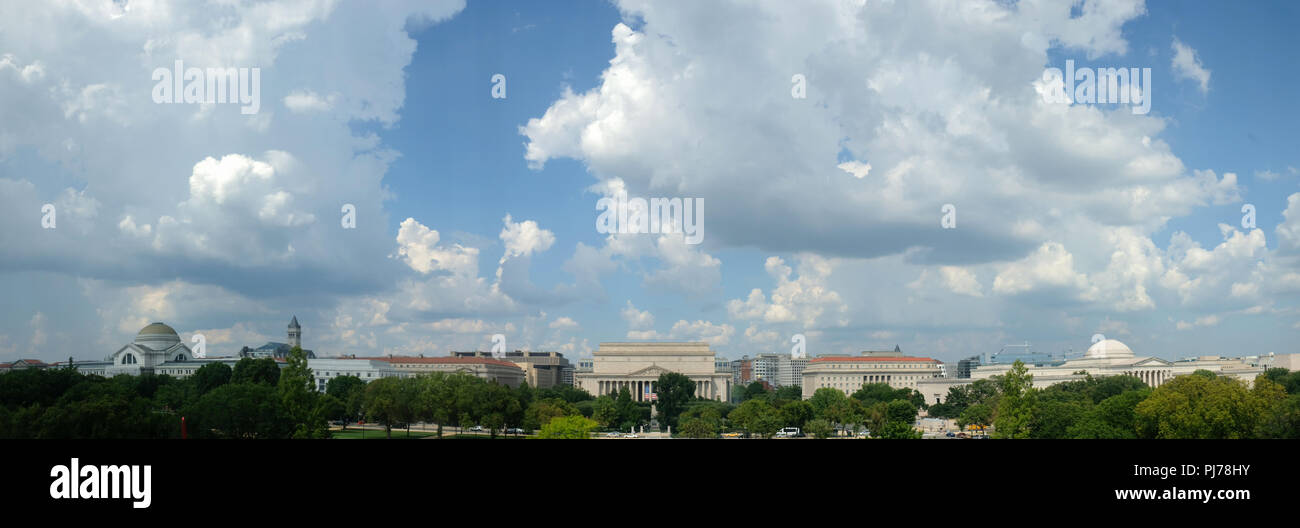 Cumulus clouds fill the sky over the National Mall in Washington, DC. National Archives are at center, Nstional Museum of Natural History at left, Nat Stock Photo