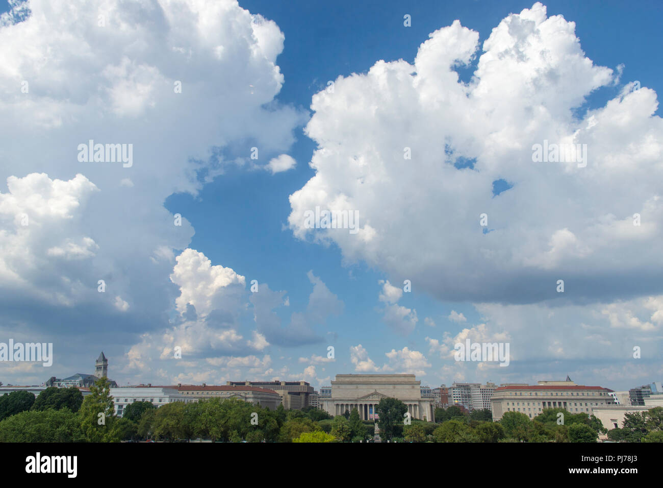 Cumulus clouds fill the sky over the National Mall in Washington, DC. National Archives are at center. Stock Photo