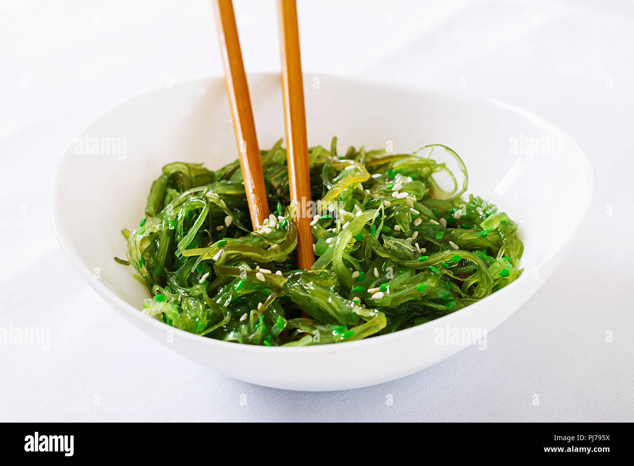 Wakame Chuka Or Seaweed Salad With Sesame Seeds In Bowl On White