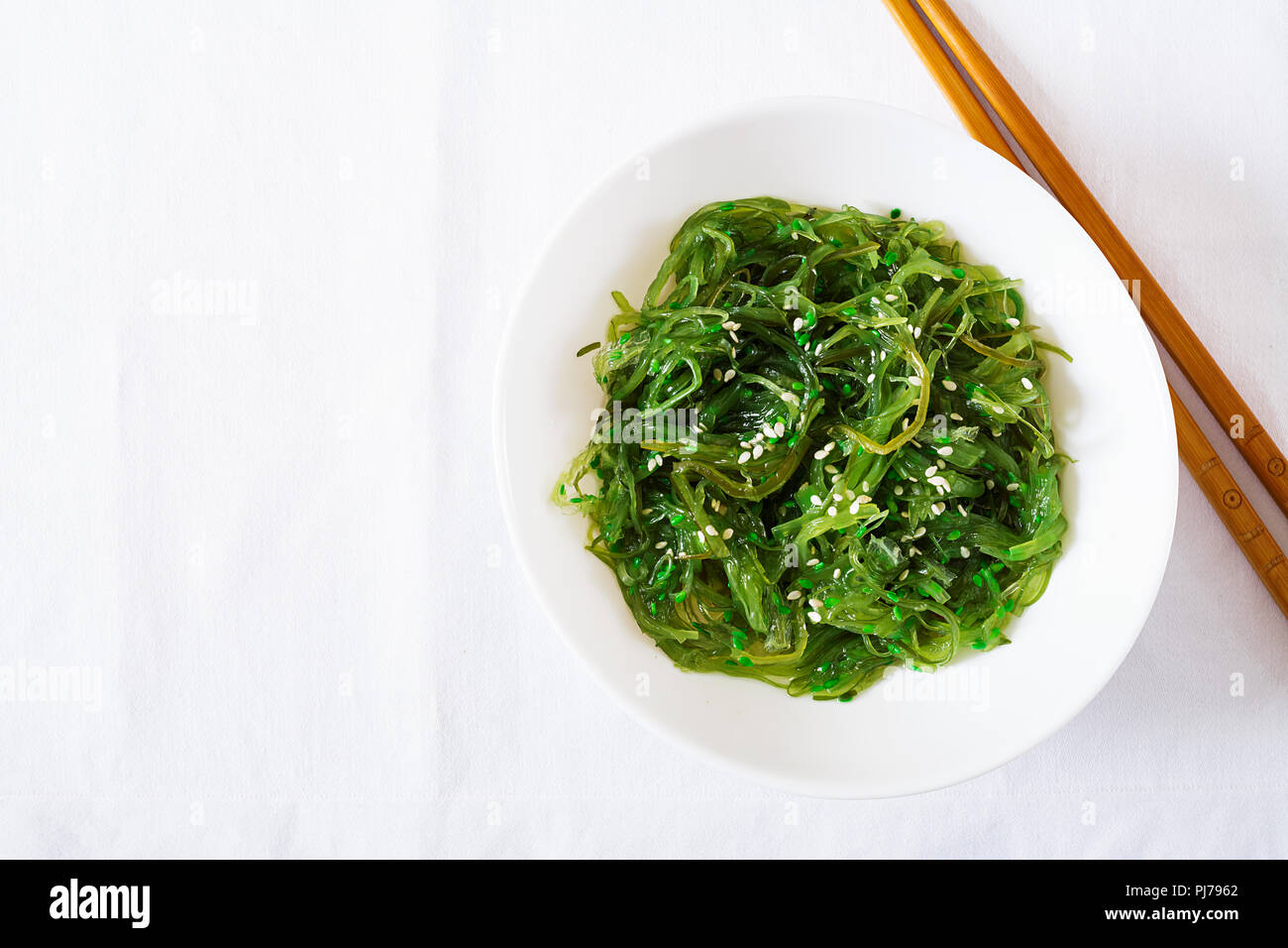 Wakame Chuka Or Seaweed Salad With Sesame Seeds In Bowl On White