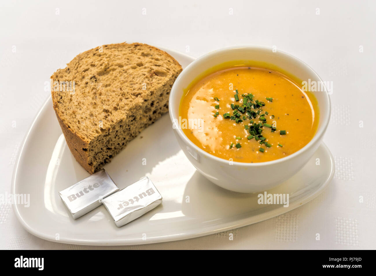 Homemade Butternut Squash Soup with herbs sprinkled on top served with