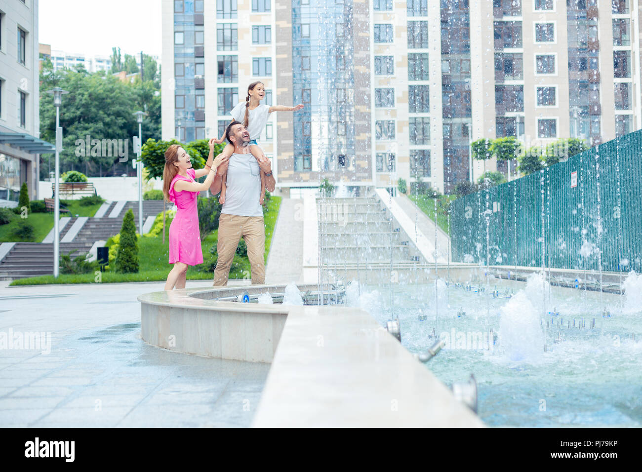 Nice joyful family having an evening walk Stock Photo