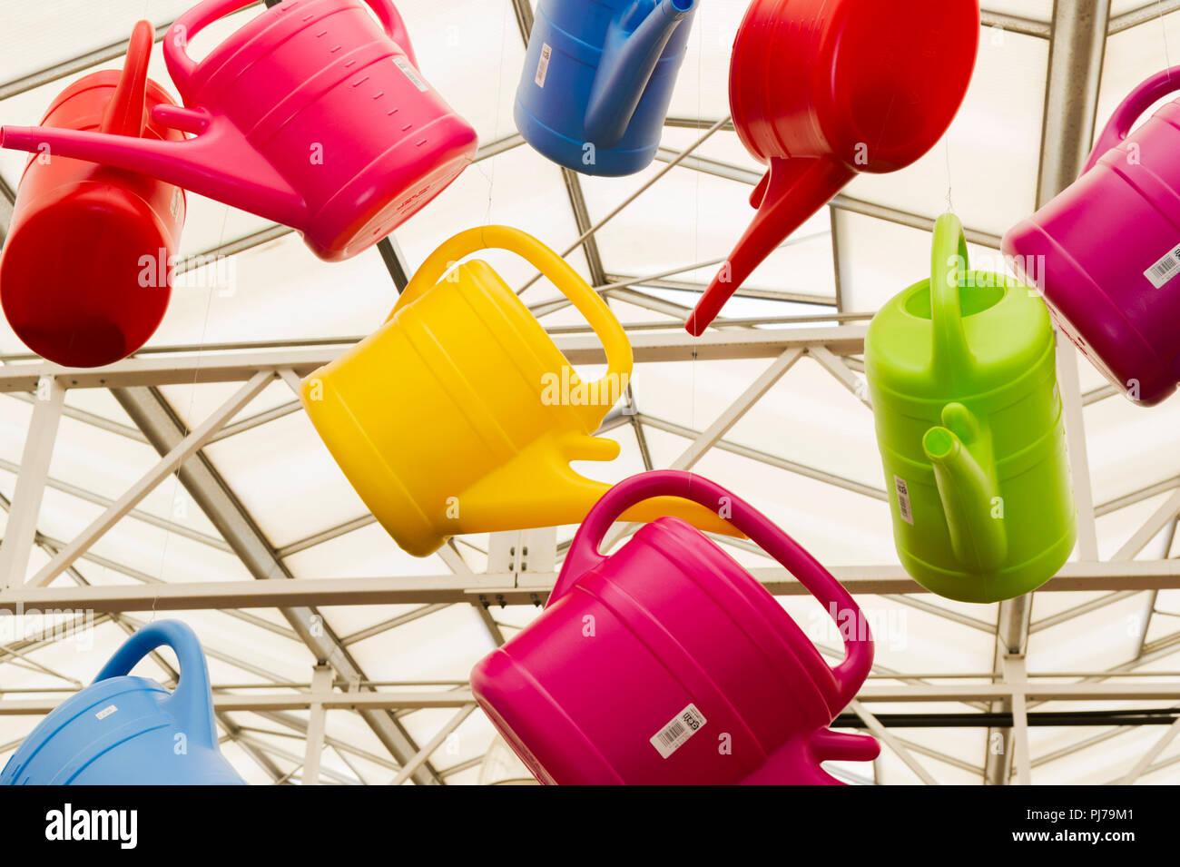 Colourful plastic watering cans on display garden centre Stock Photo Alamy