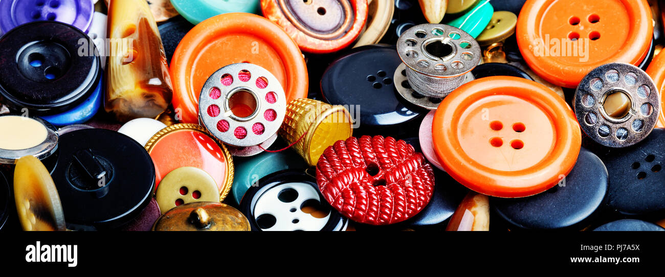 Lots of colorful buttons for clothes on wooden background Stock Photo -  Alamy