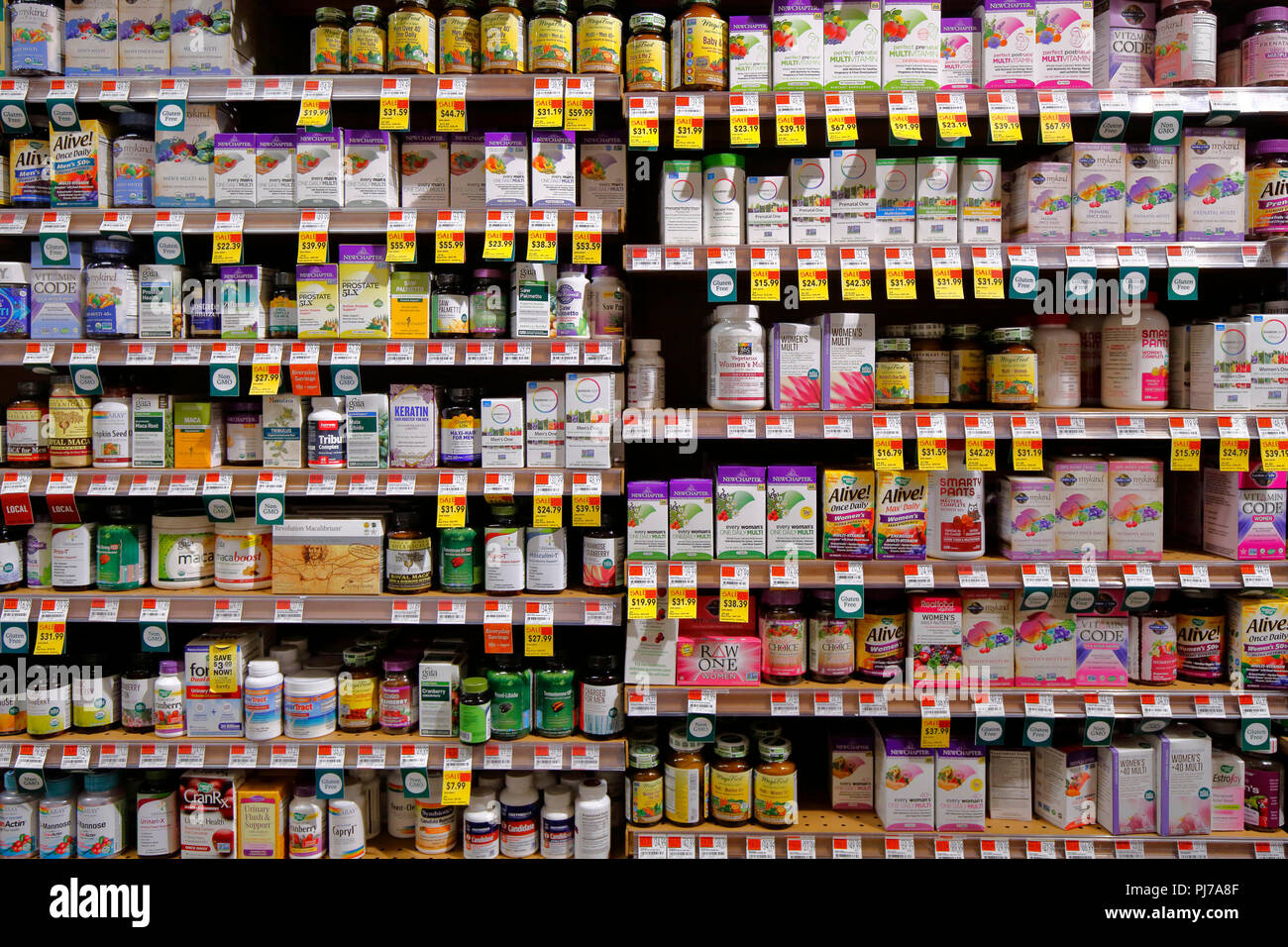 Different brands and varieties of vitamins, minerals, and nutritional supplements at a health foods store, a paradox of choice for the consumer Stock Photo