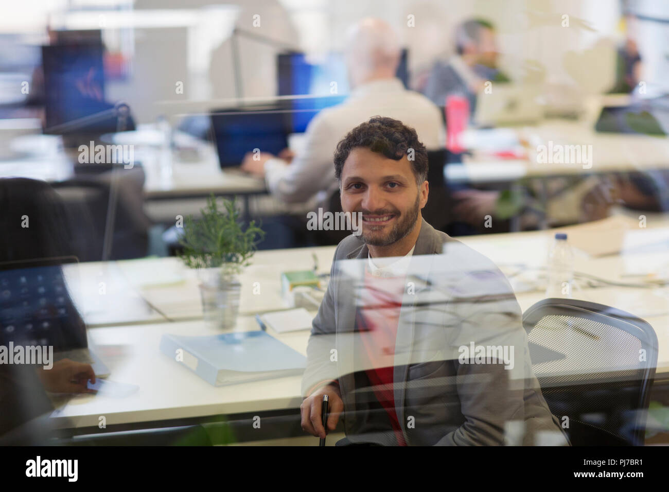 Portrait smiling, confident businessman working in office Stock Photo