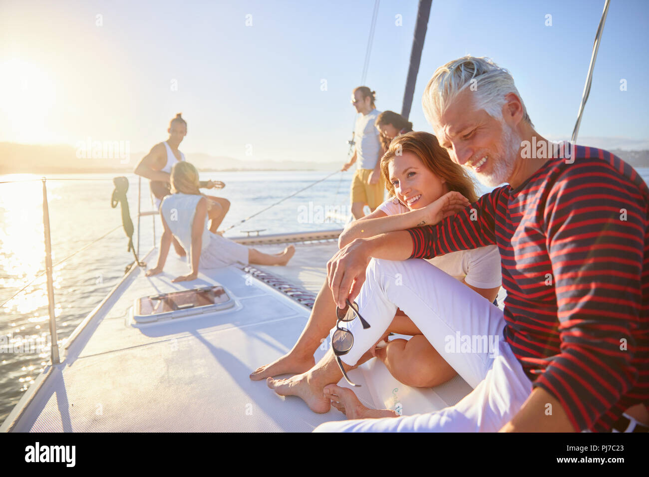 Friends relaxing on sunny catamaran Stock Photo