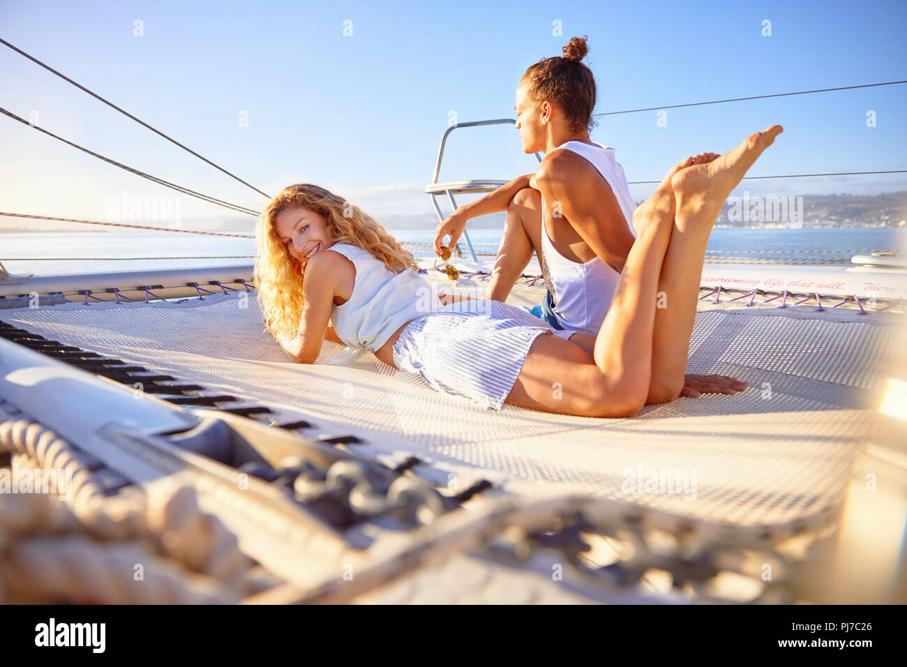Portrait smiling woman relaxing on sunny catamaran Stock Photo