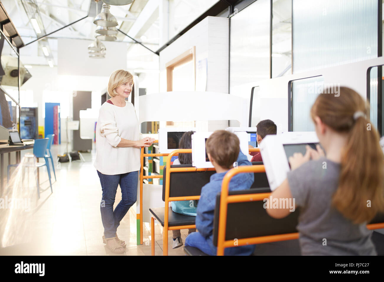 Teacher and students using touch screen computers Stock Photo