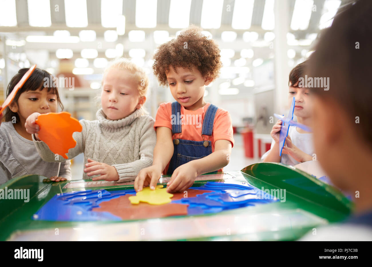 Kids playing at interactive exhibit in science center Stock Photo - Alamy
