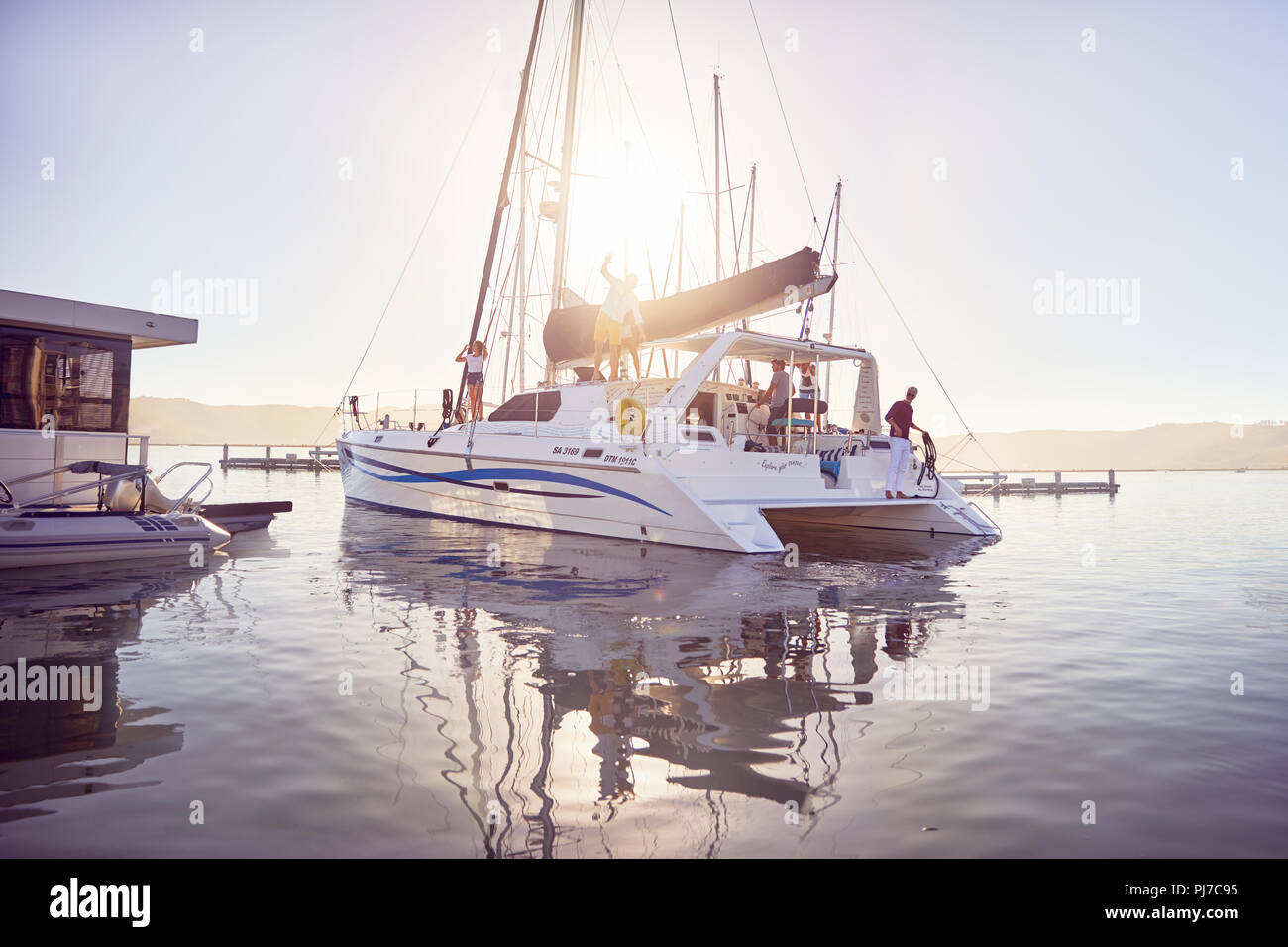 Catamaran in sunny ocean harbor Stock Photo