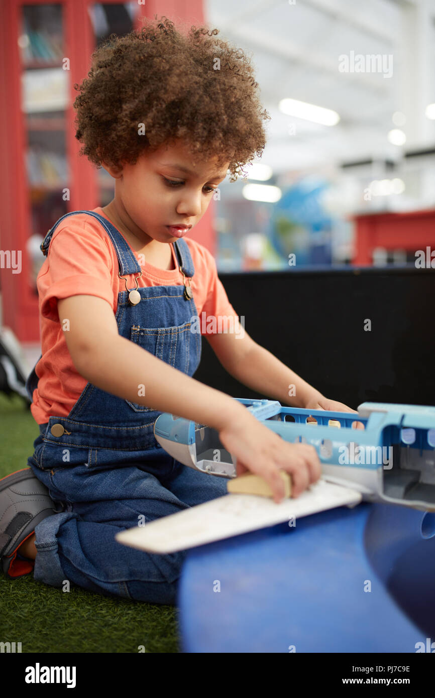 Curious girl playing in science center Stock Photo