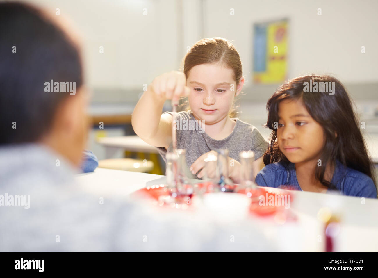 Curious girls at interactive exhibit in science center Stock Photo