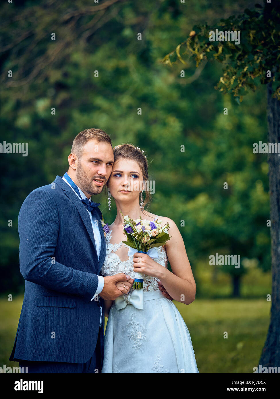 Solemn ceremony of marriage of the newlyweds. Customs and traditions inherited from a past life in the old Soviet Union. People have fun, drinking. Stock Photo