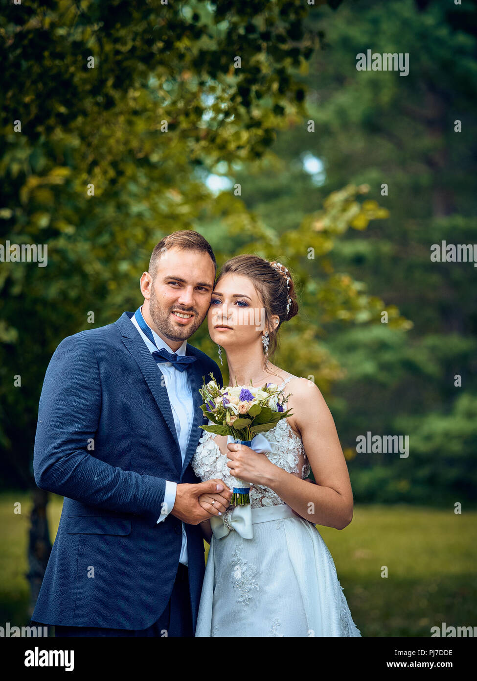 Solemn ceremony of marriage of the newlyweds. Customs and traditions inherited from a past life in the old Soviet Union. People have fun, drinking. Stock Photo