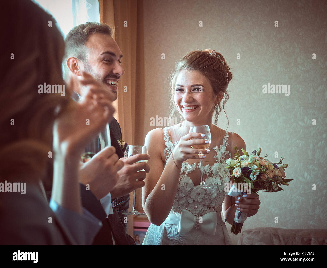 Solemn ceremony of marriage of the newlyweds. Customs and traditions inherited from a past life in the old Soviet Union. People have fun, drinking. Stock Photo