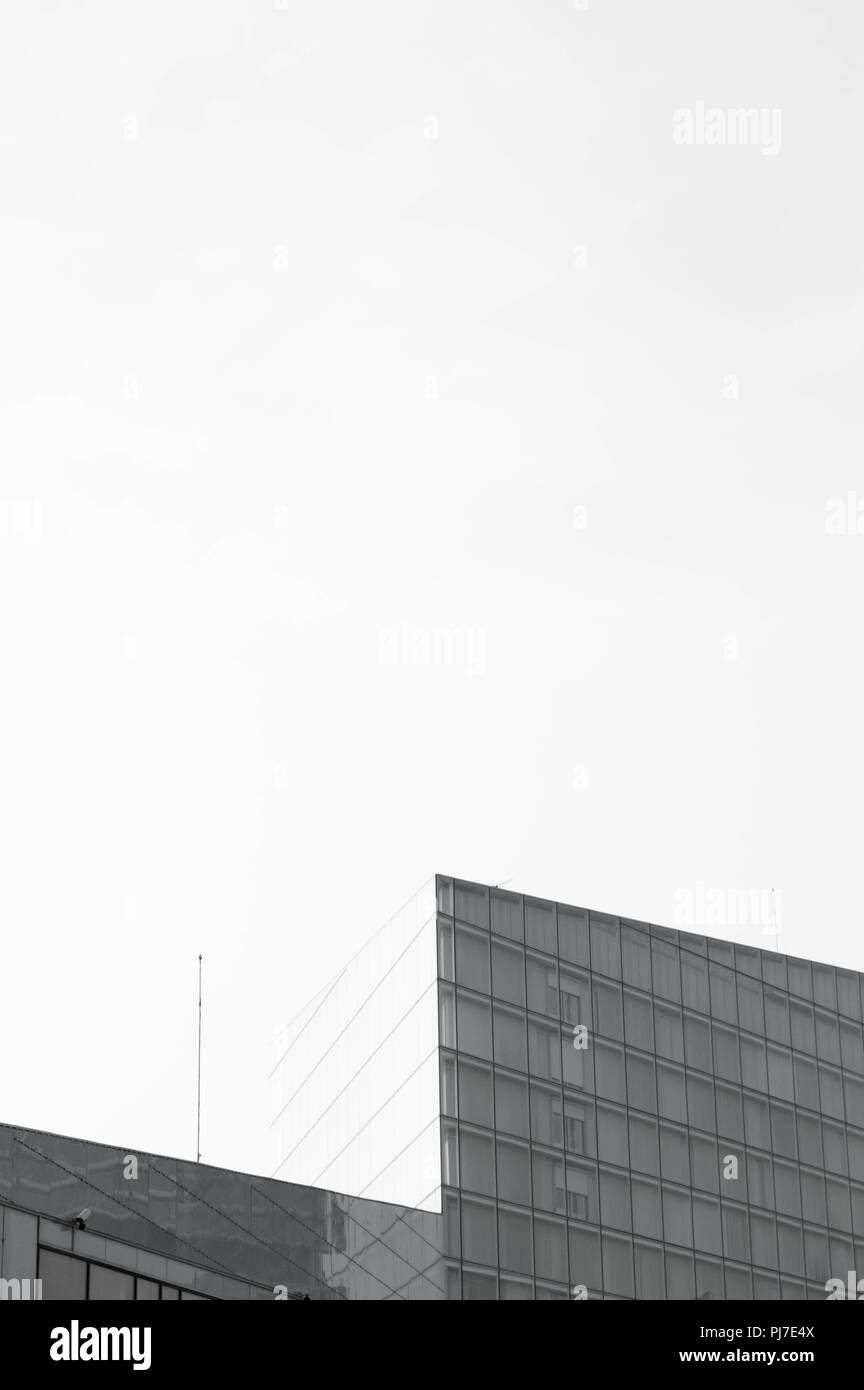 Stunning architectural dynamic shape building with blank space. Black and white Stock Photo