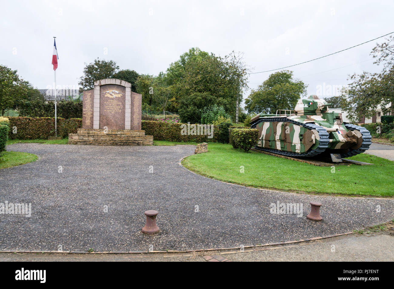 A French World War 11 armoured tank guarding a war memorial in Stonne, a village in the Ardennes of northern France.   Stonne  was heavily contested d Stock Photo