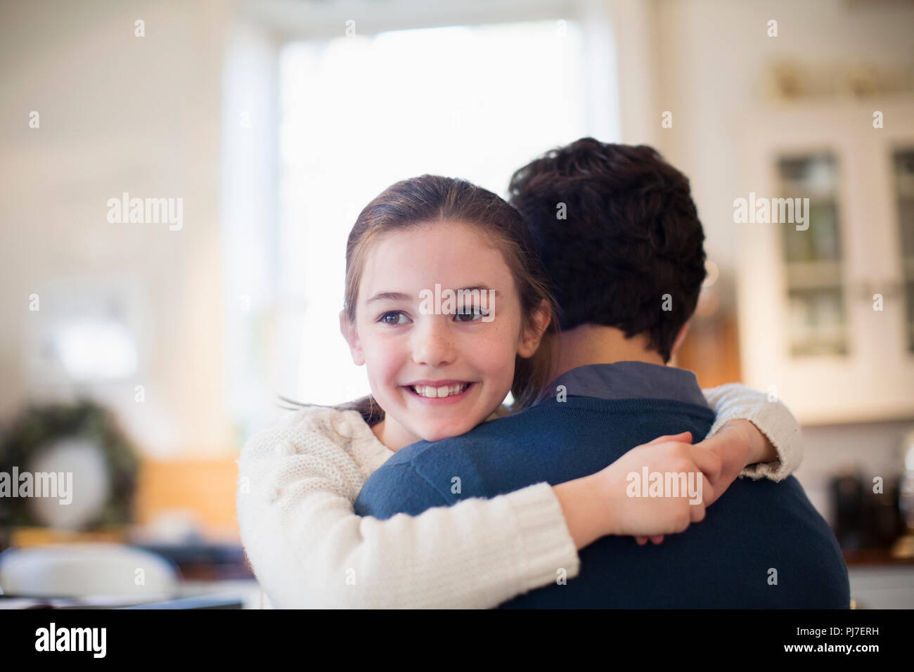Happy daughter hugging father Stock Photo