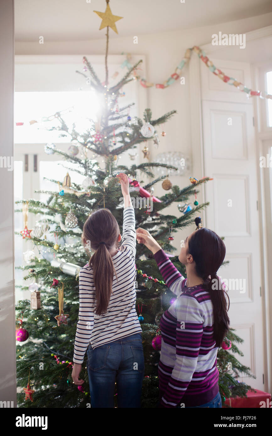 Woman decorating tree rear view hi-res stock photography and images - Alamy