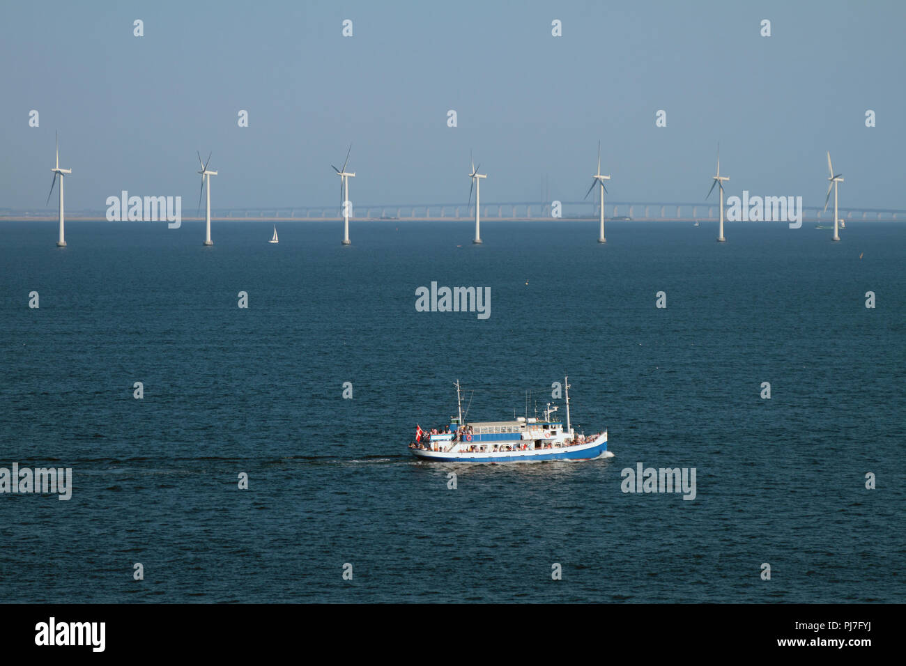 Sea, walking motor ship and wind generators. Copenhagen, Denmark Stock Photo