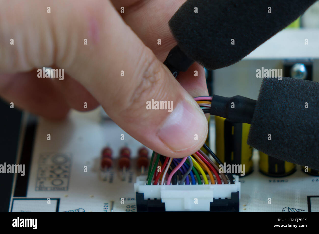 Quality control and assembly of SMT printed components on circuit board in QC lab of PCB manufacturing high-tech factory Stock Photo