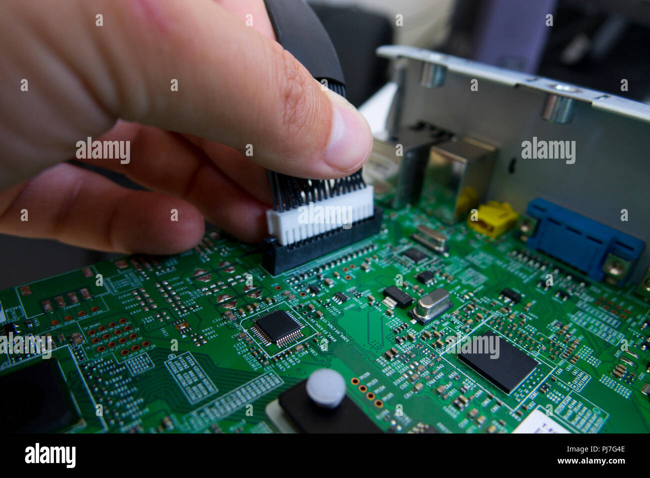 Quality control and assembly of SMT printed components on circuit board in QC lab of PCB manufacturing high-tech factory Stock Photo