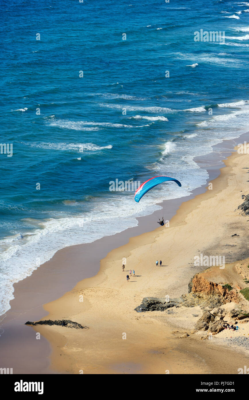 Paragliding over Cordoama beach. Algarve, Portugal Stock Photo
