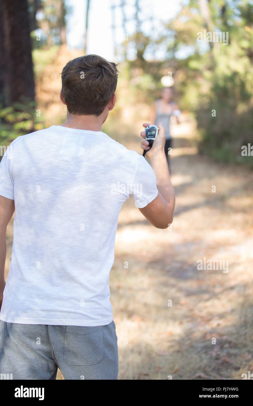 Man with stopwatch waiting for running to arrive Stock Photo Alamy