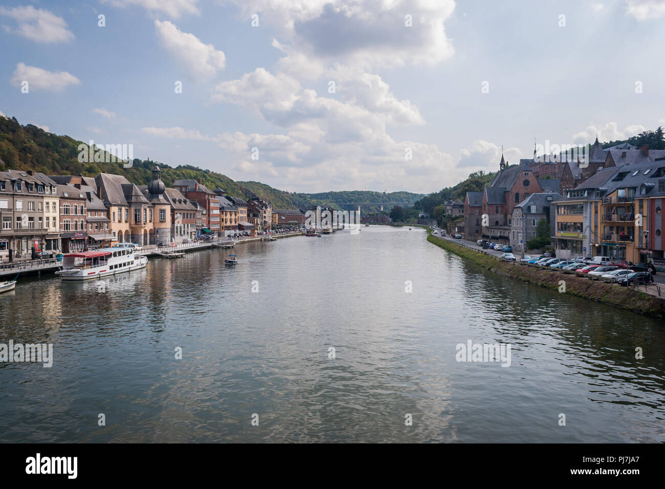 Looking down the River Meuse in Dinant, Belgium, from famous Saxophone Bridge on a sunny day. Stock Photo
