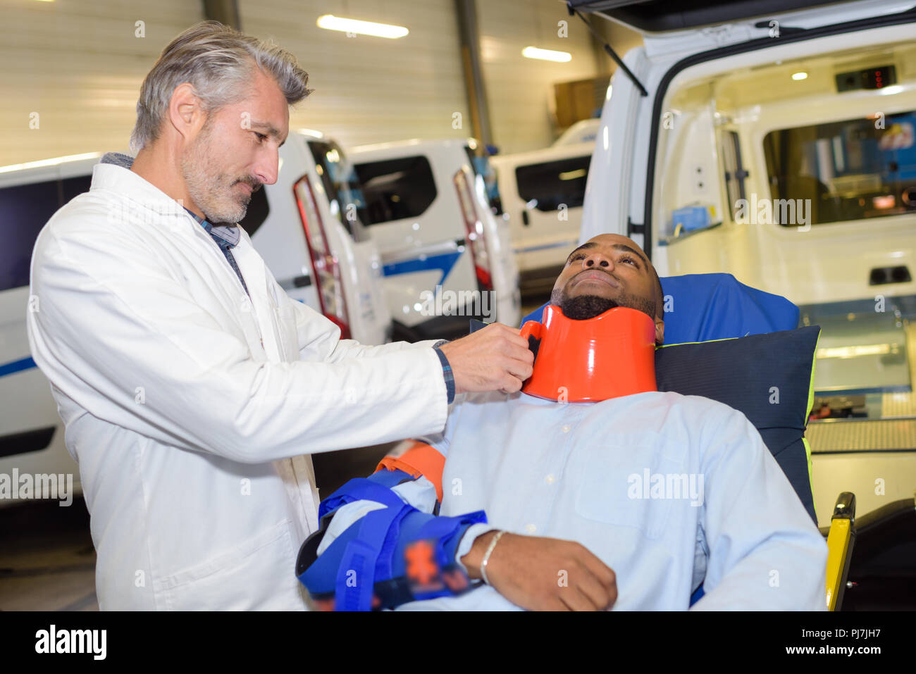 Paramedic securing neck brace to patient Stock Photo Alamy
