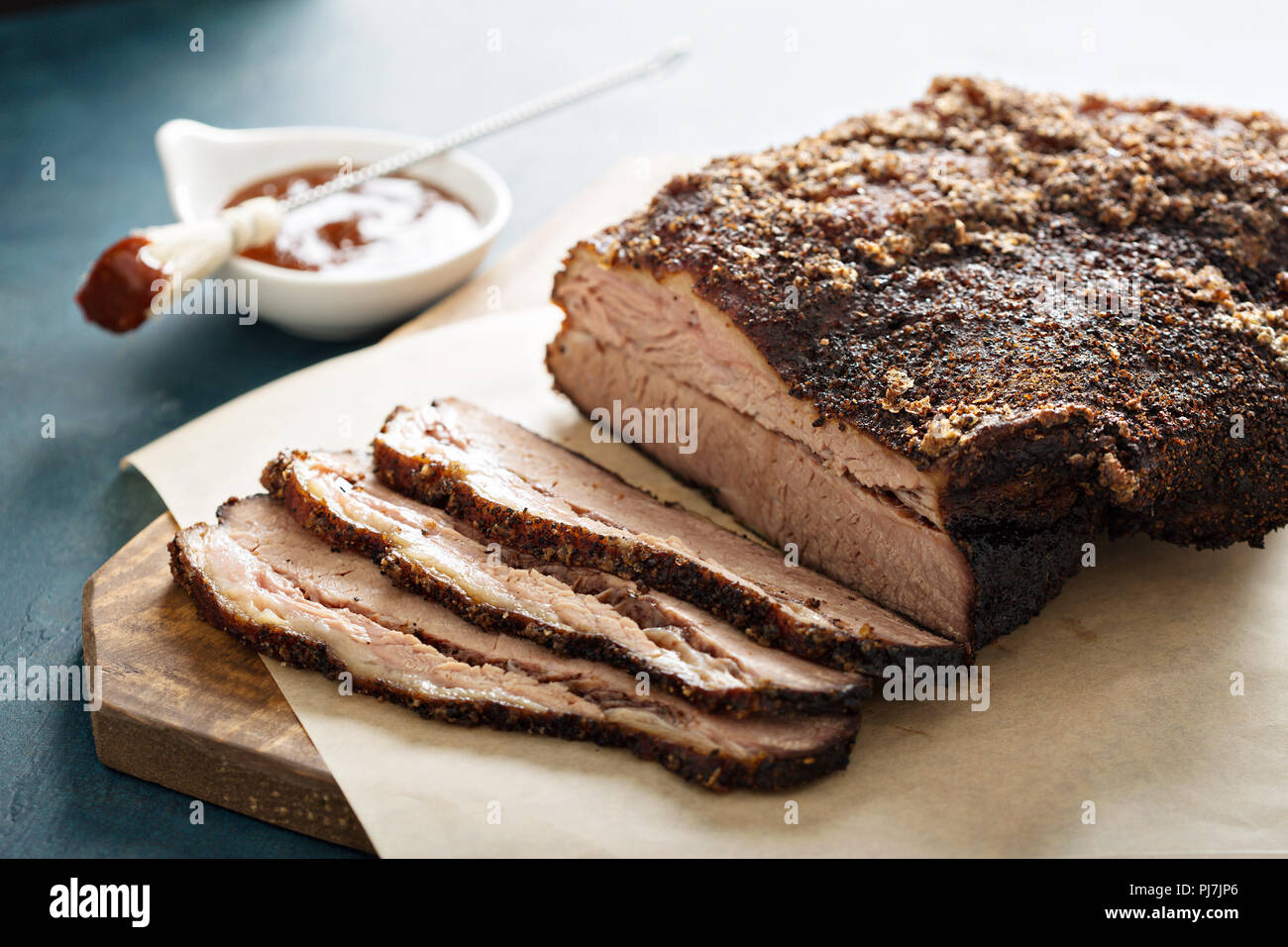 Sliced slowly cooked brisket with bbq sauce Stock Photo Alamy
