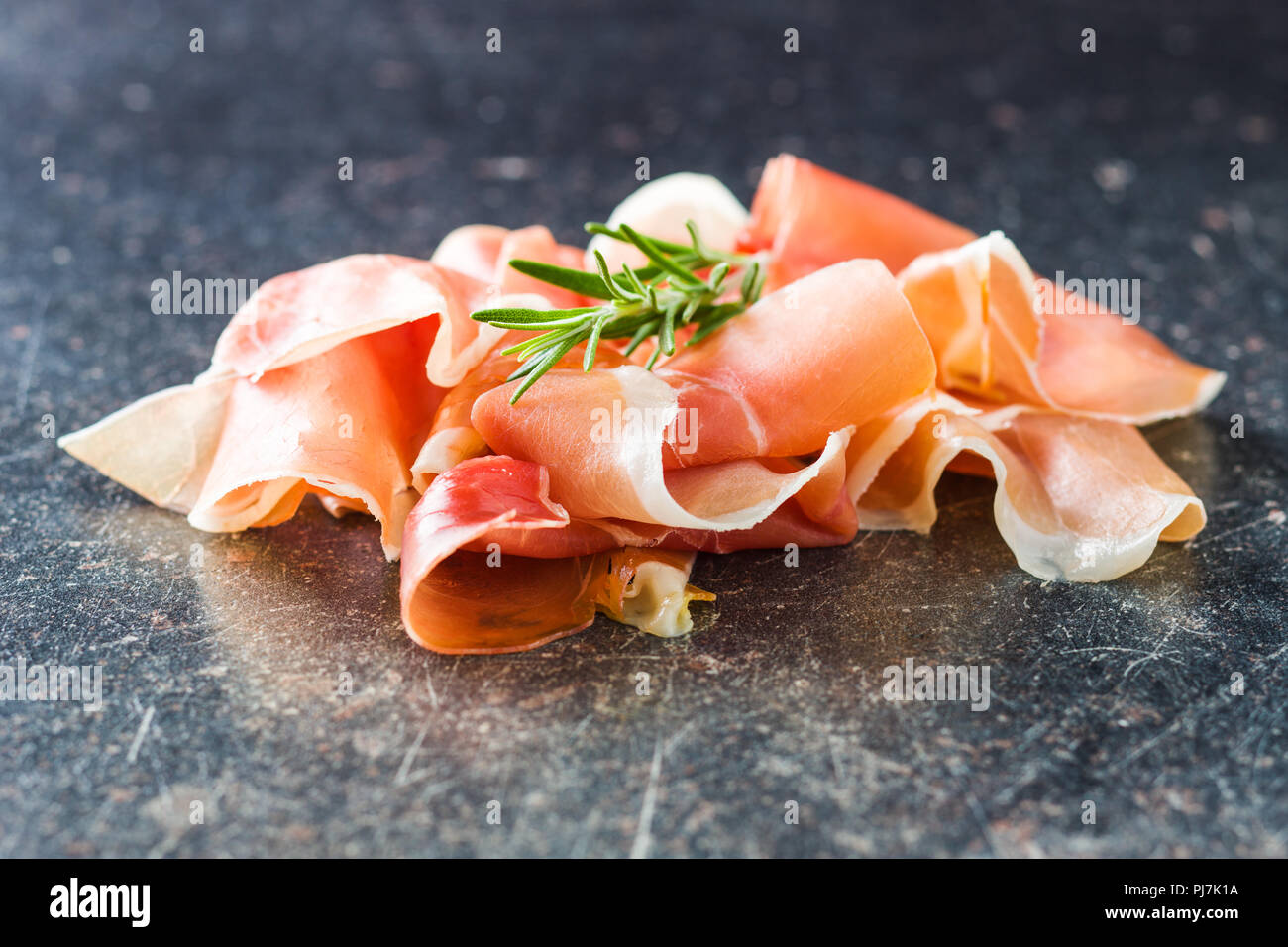 Italian prosciutto crudo or jamon on old kitchen table Stock Photo Alamy