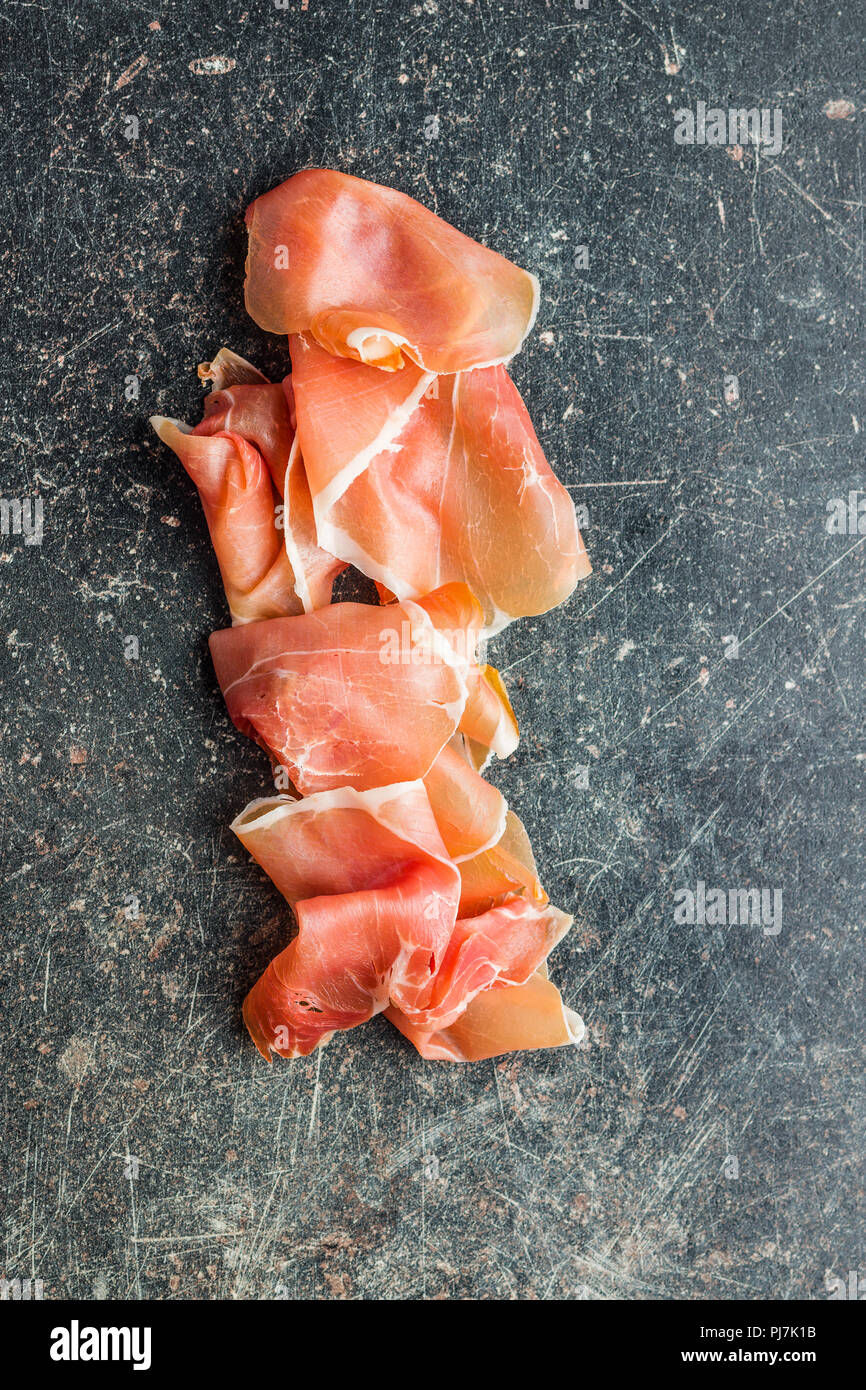 Italian prosciutto crudo or jamon on old kitchen table Stock Photo Alamy