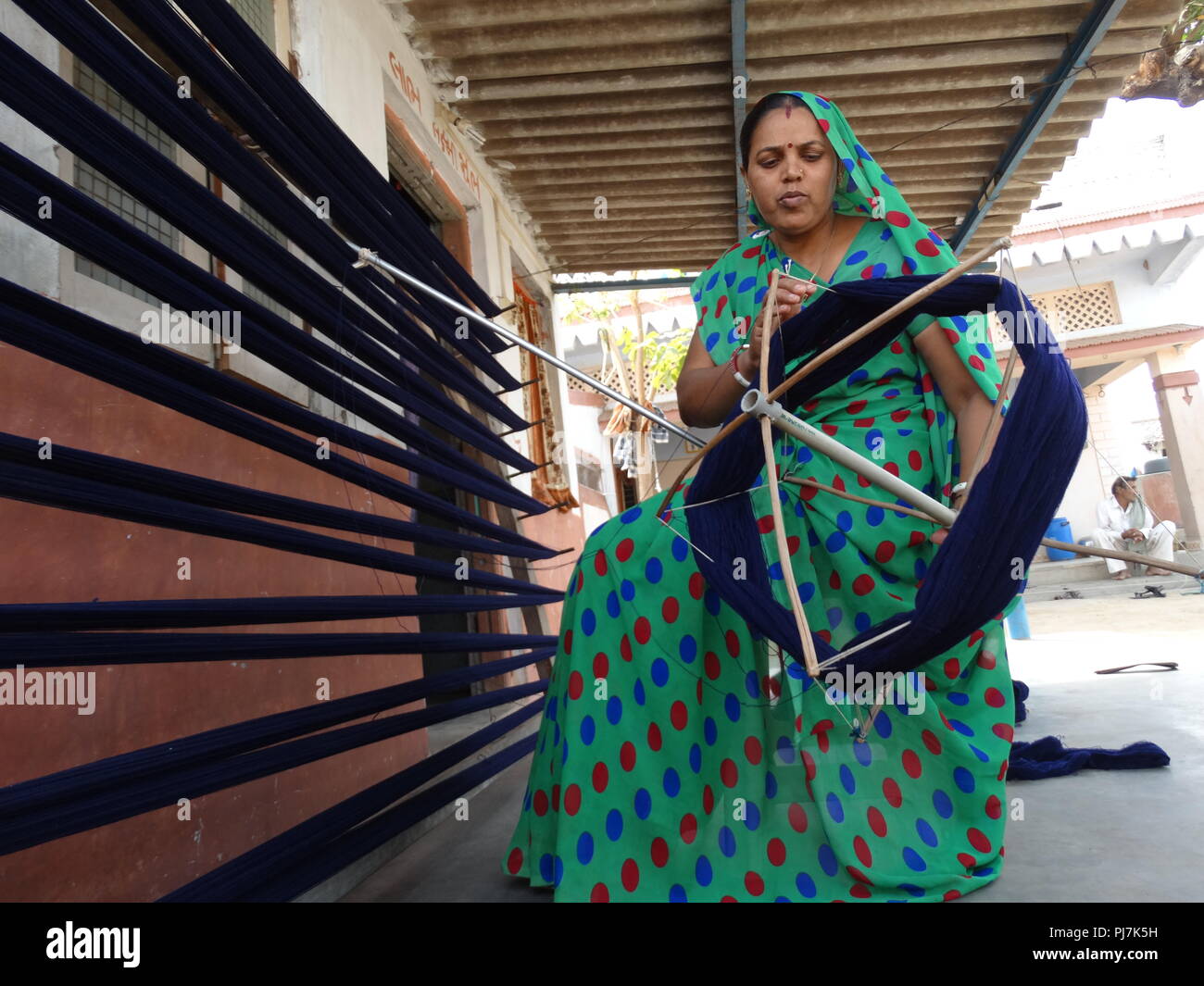 Indian working woman busy weaving Stock Photo