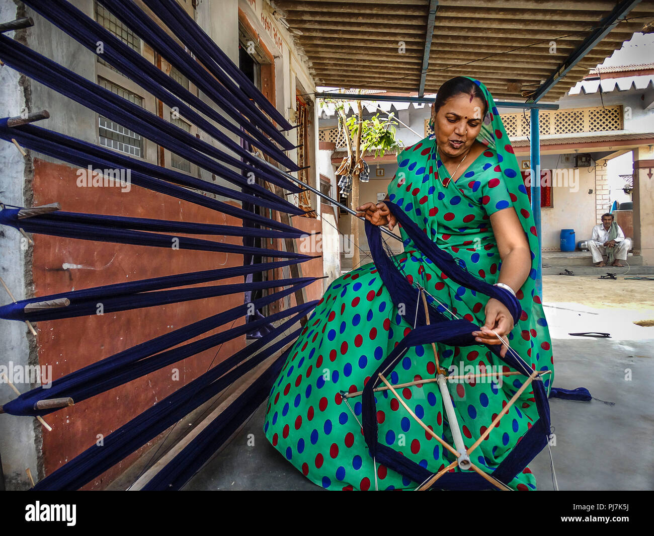 Indian working woman busy weaving Stock Photo